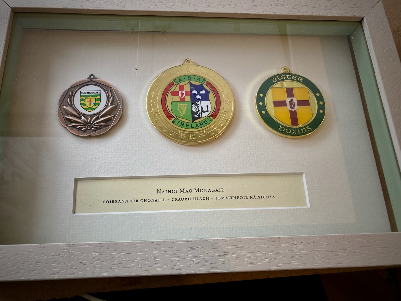 Box frame picturing Donegal boxing champion medals
